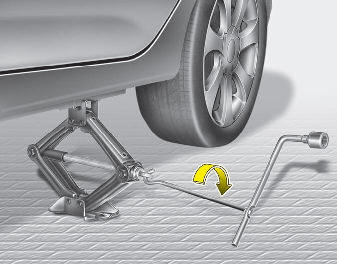 Hyundai Elantra: Changing tires. 9. Insert the jack handle into the jack and turn it clockwise, raising the vehicle